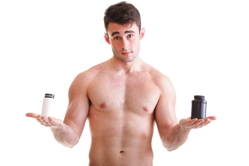 man holding supplement bottles