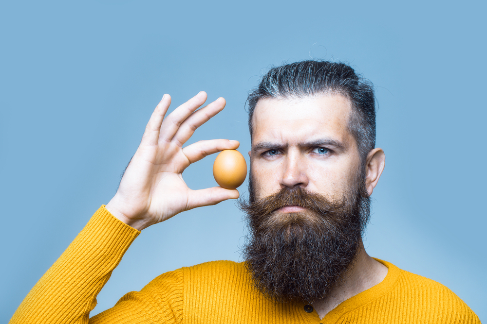 masculine guy holding egg