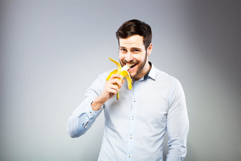 man enjoying a banana