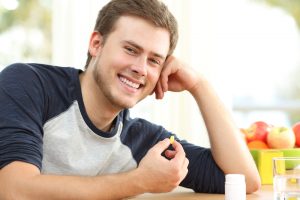 healthy man taking supplement