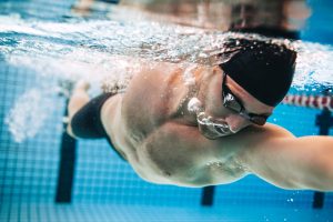 fit guy swimming for fitness