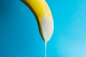 cream drips from banana as semen