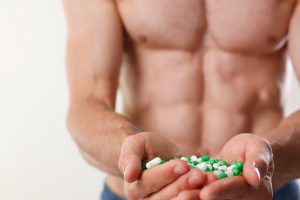 fit guy holds loads of pills