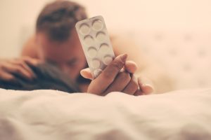 couple holds enhancement pills during sex