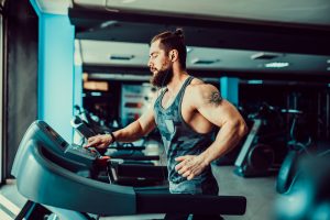 fit man running on treadmill for cardio