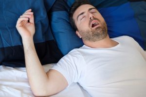 snoring man with sleep apnea