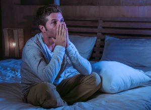 depressed man in bed at night