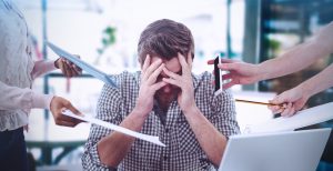 man stressed out at work