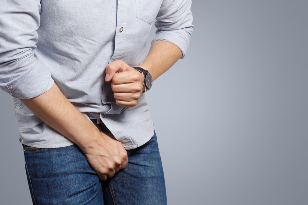 man clutching painful junk