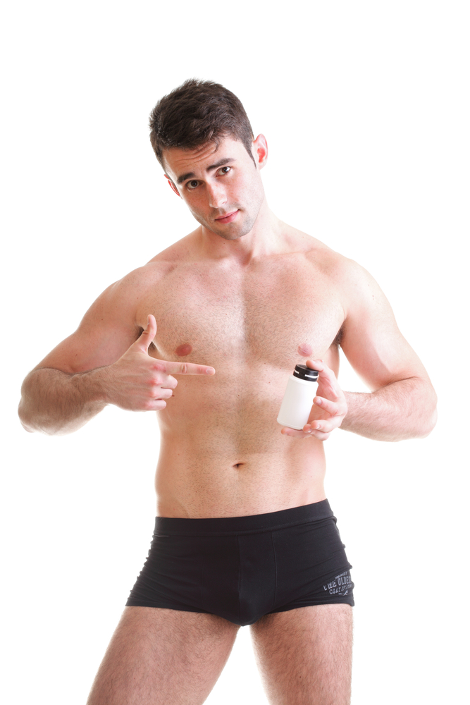 man in underwear with male enhancement supplement bottle