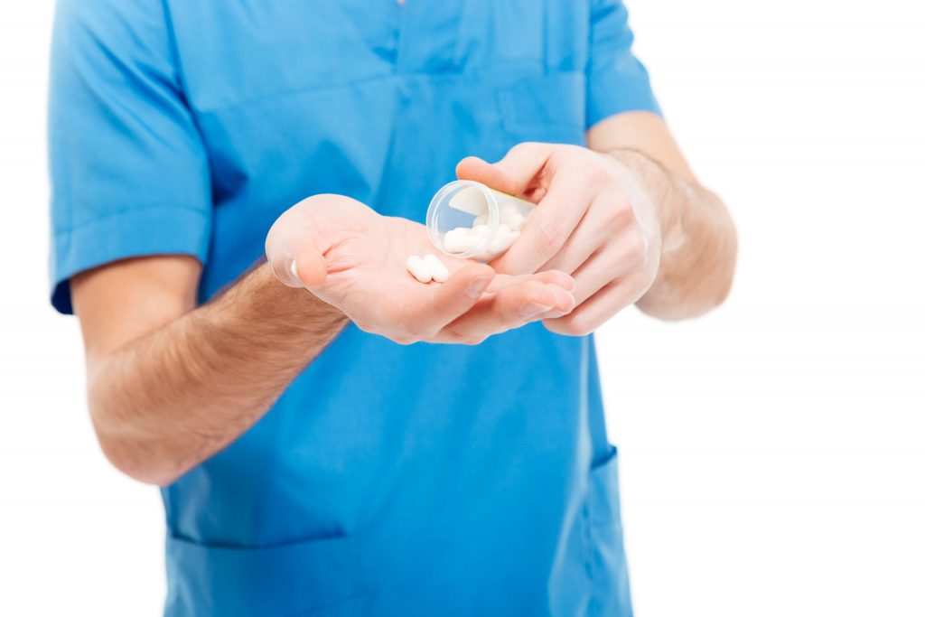 medical professional holding pills