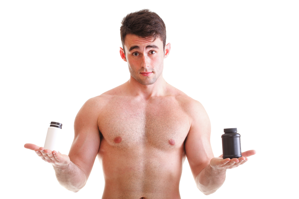 young man with male enhancement supplement bottles