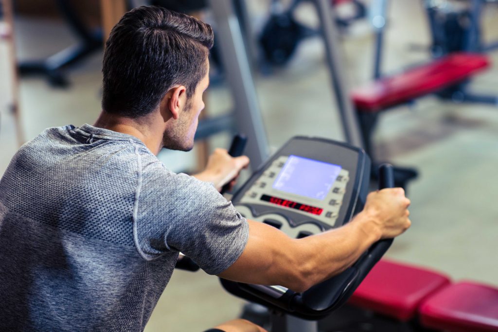 fit guy on stationary bike