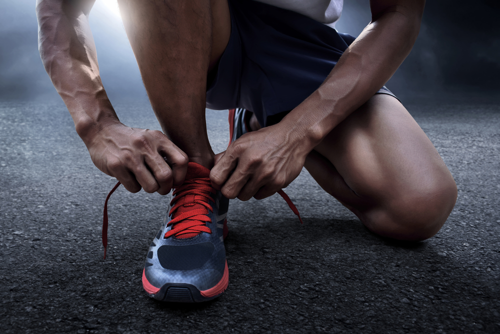 tying his running shoes