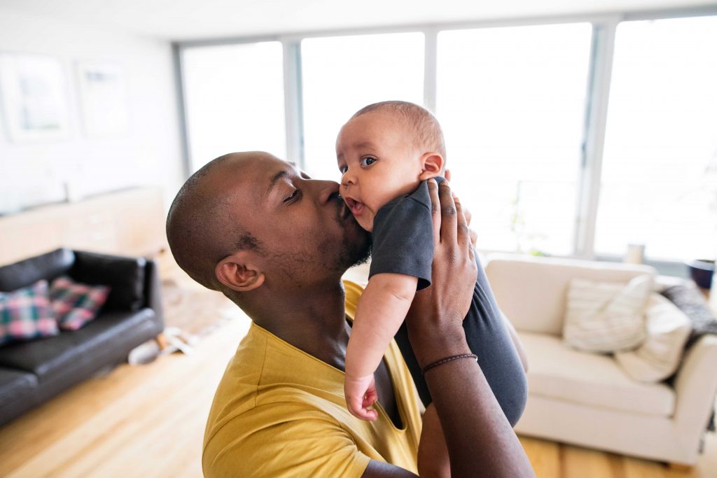 dad giving son a kiss