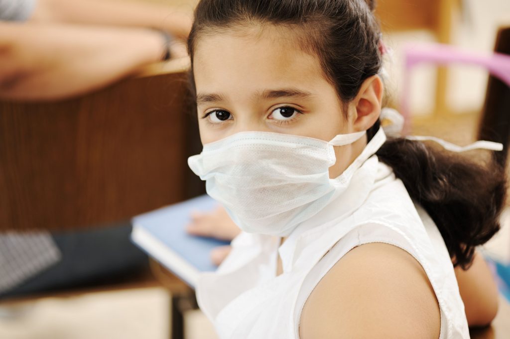young girl wearing surgical mask