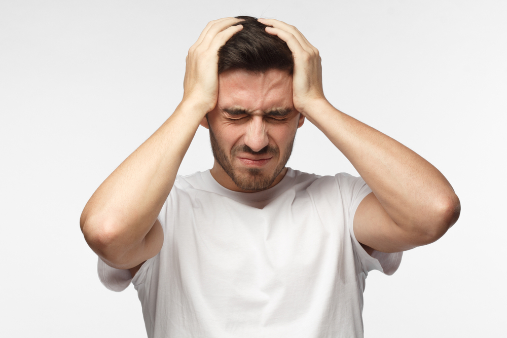 man suffers from migraine