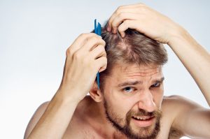 checking his scalp and hair