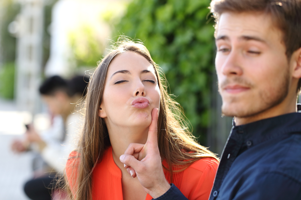 man avoiding kiss