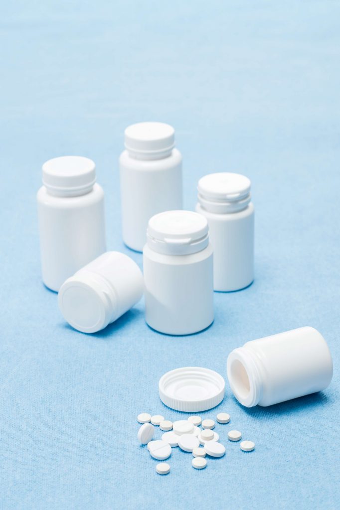 white pill bottles and tablets