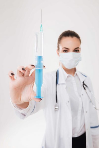 doctor holding a syringe