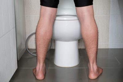 man peeing in toilet