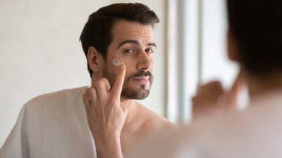 man putting on a moisturizer